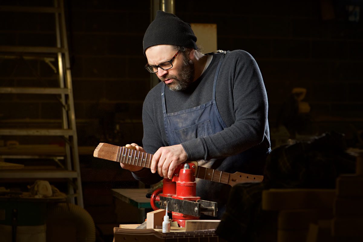 A professional commercial photographer photographing a craftsman.