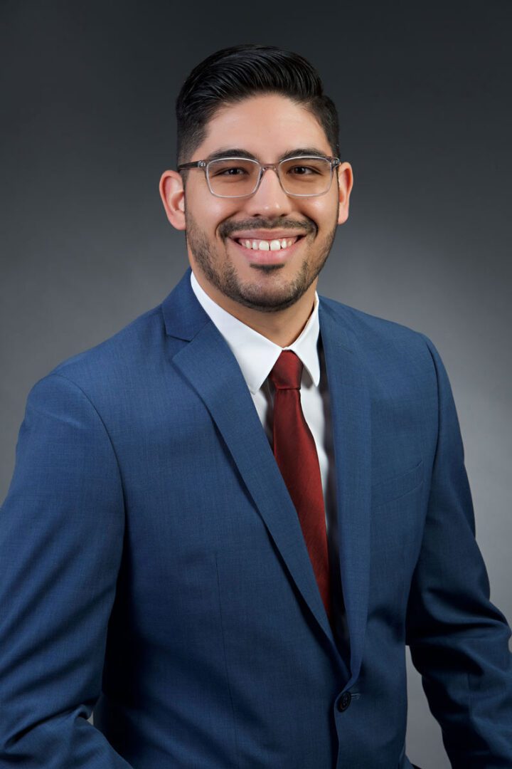 man in blue suit and red tie
