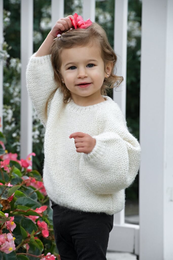 a cute little girl in a white top